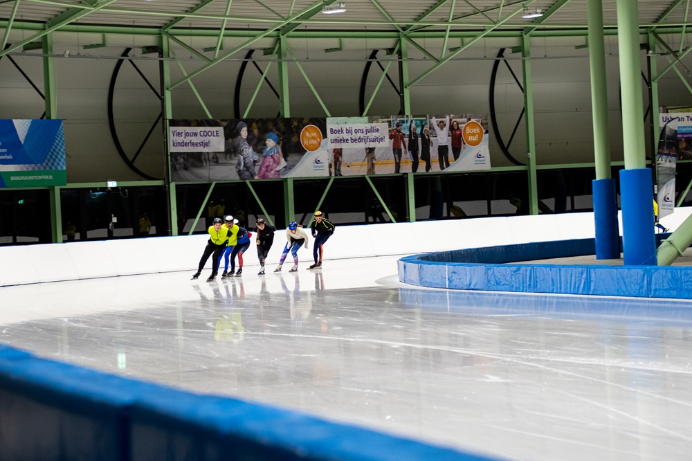 Een groep schaatst in een treintje rondjes tijdens het norenuur