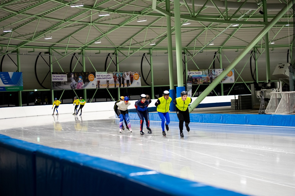 Een groep schaatst in een treintje rondjes tijdens het norenuur